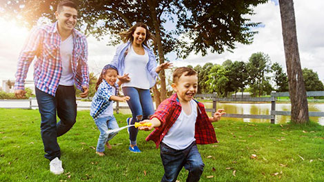 family of four playing in a park