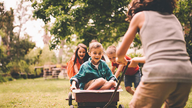family of five playing outdoors