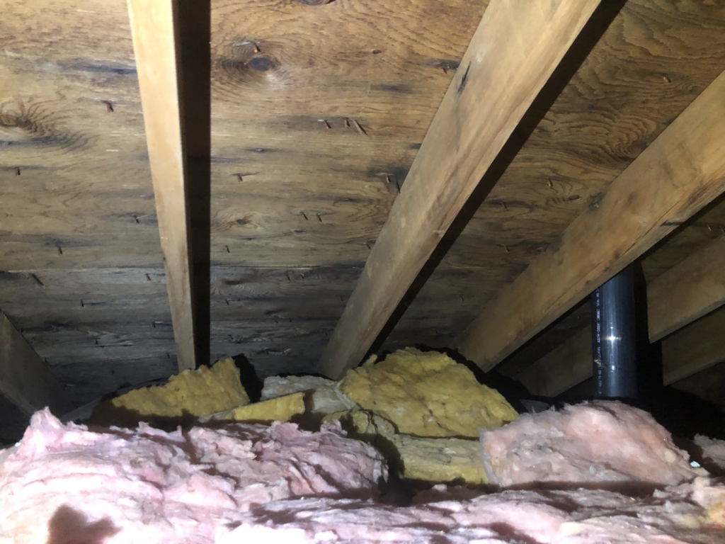 attic with old, damaged insulation