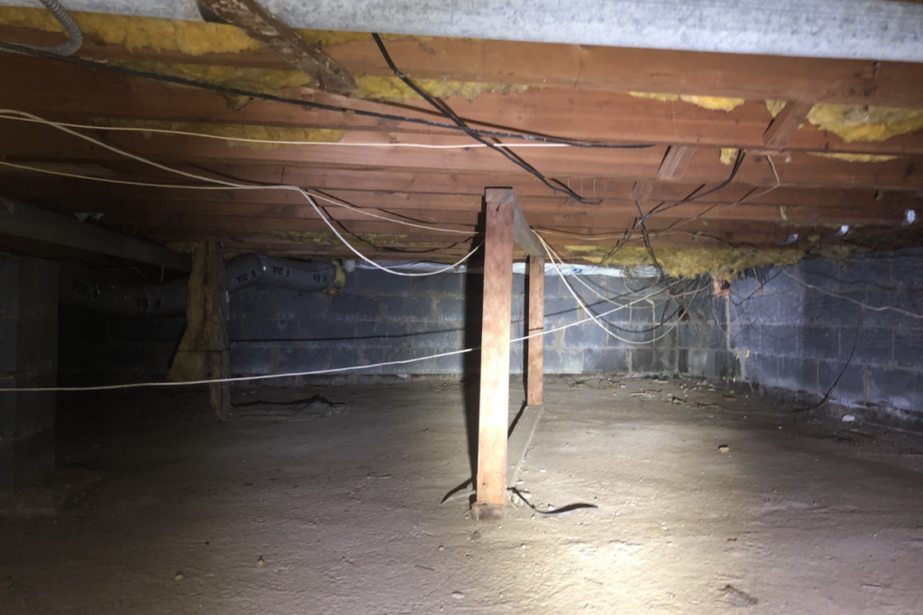 dirty damp crawl space in need of a french drain drainage system