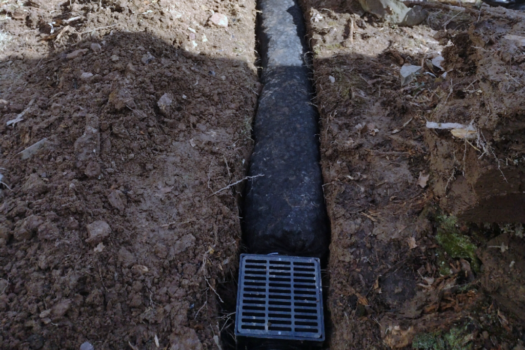 process of external French drain being installed