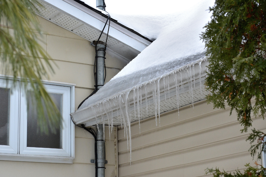 snow and ice melting on rooftop that can cause foundation damage