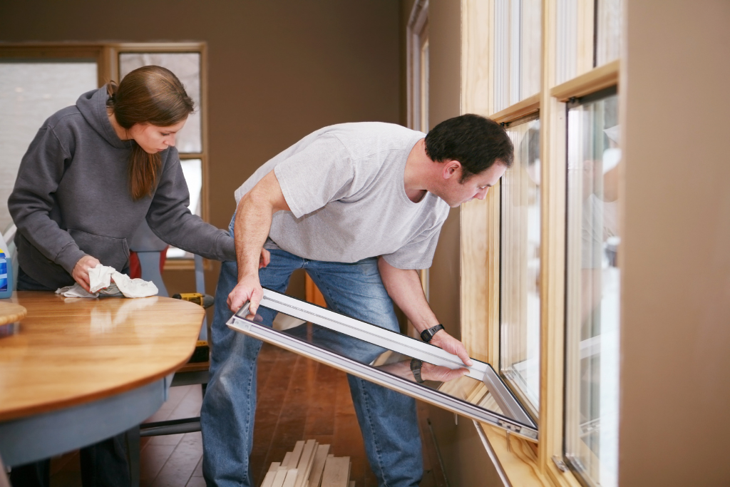 couple improving the window sealing of their home