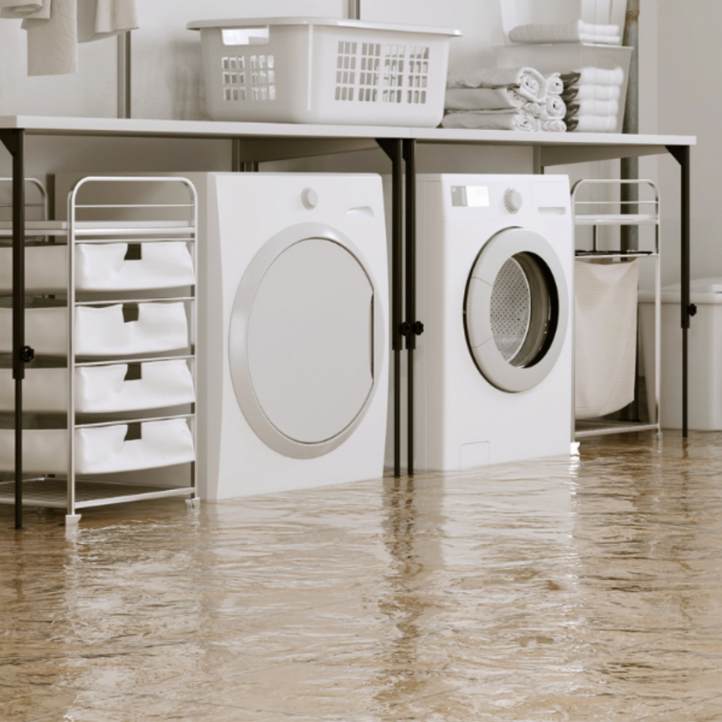 flooded basement with washer and dryer in standing water