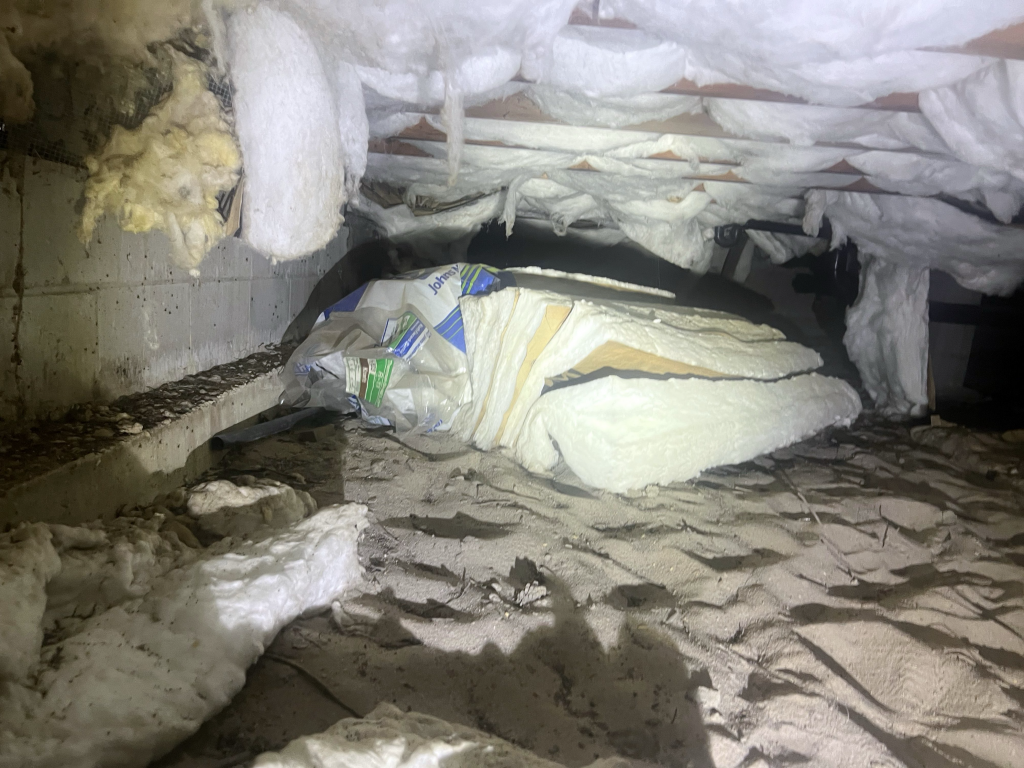 falling and damaged insulation in the crawlspace, indicating a need for an insulation upgrade